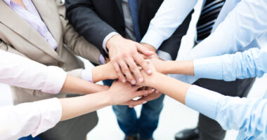 Business people joining hands in circle